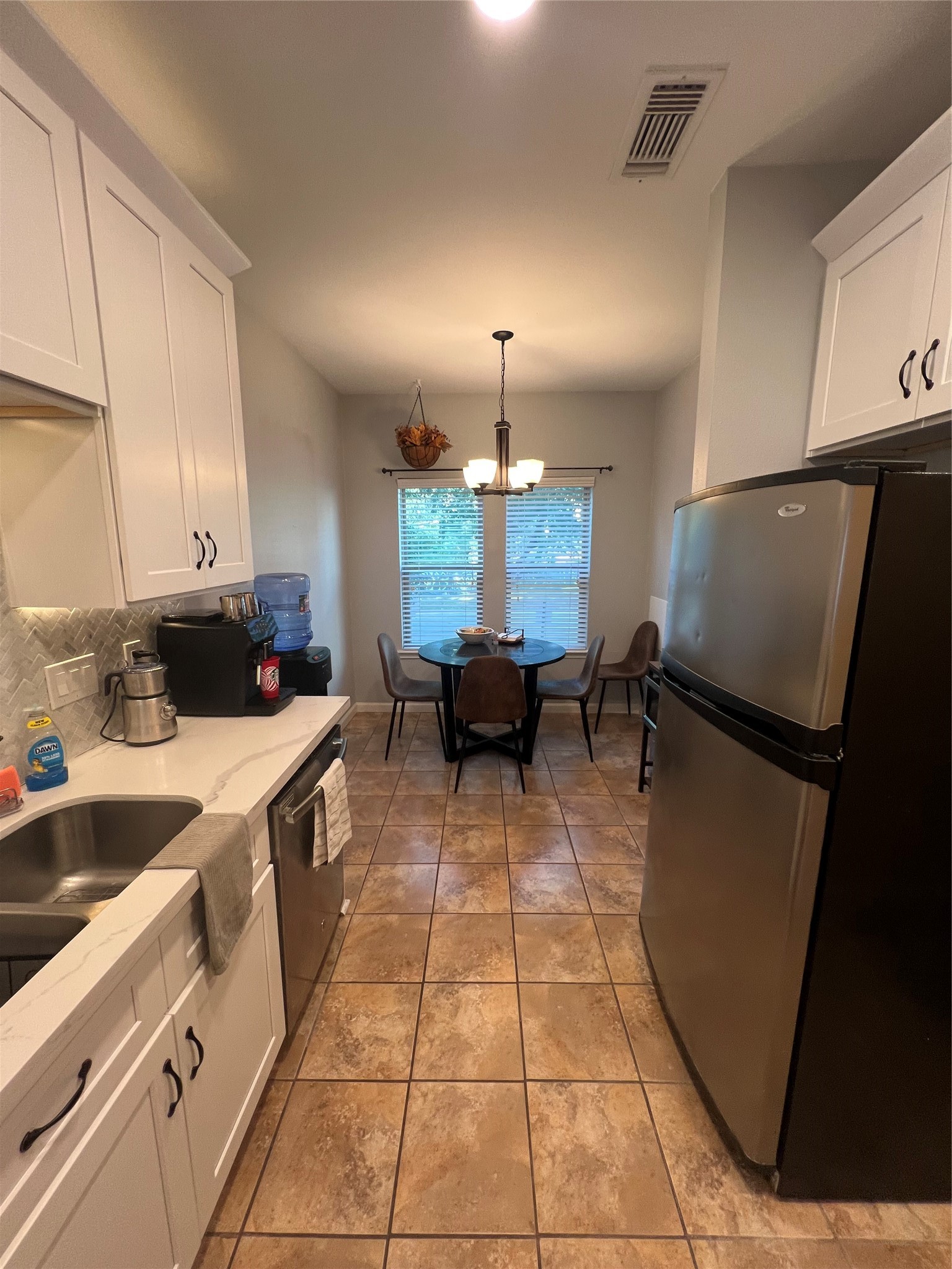 2414 Longview Street, Unit 202 Austin, TX 78705 - Photo 7 of 17 Functional kitchen featuring white
cabinetry and modern appliances.