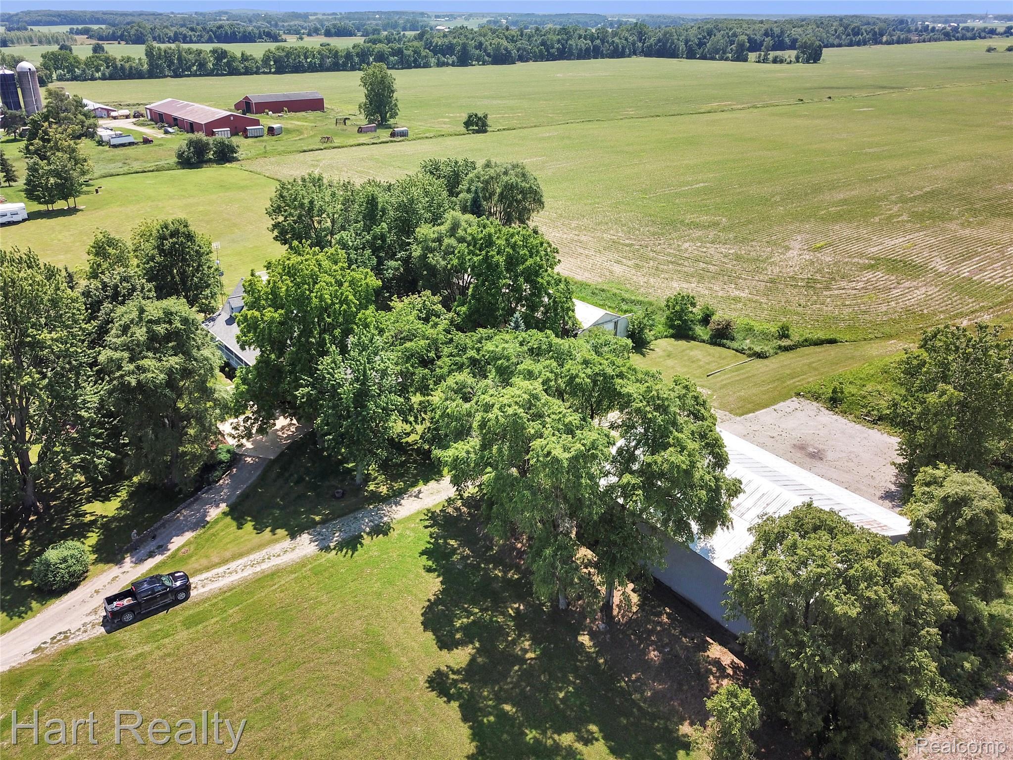 7167 Brown School Road North Branch, MI 48461 - Photo 46 of 51 Expansive rural property featuring multiple outbuildings, mature trees, and agricultural land