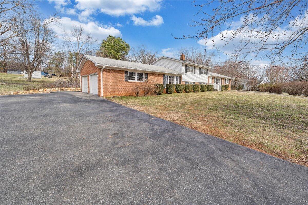 160 Bernard Road Rocky Mount, VA 24151 - Photo 54 of 56 a view of a house next to a big yard with large trees