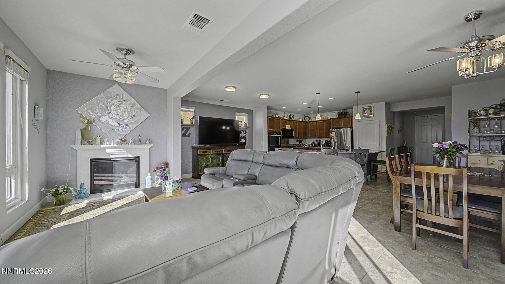 9111 Kenton Trail Reno, NV 89523 - Photo 5 of 49 a living room with furniture a fireplace and a chandelier