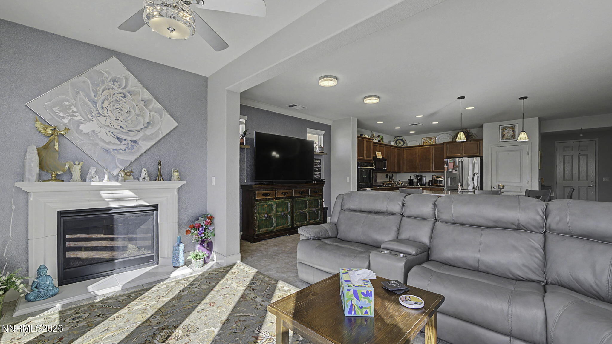 9111 Kenton Trail Reno, NV 89523 - Photo 8 of 49 a living room with furniture a fireplace and a flat screen tv