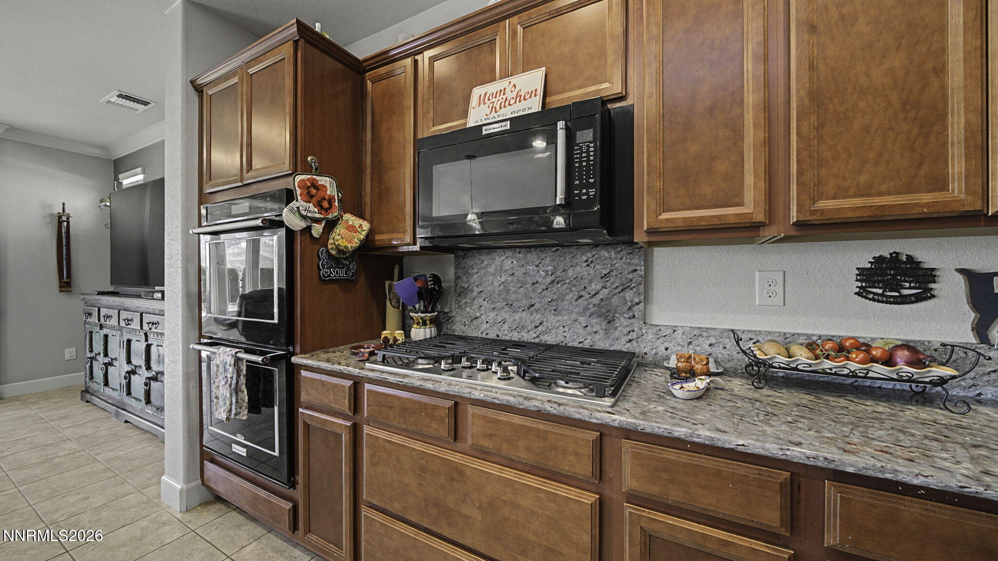 9111 Kenton Trail Reno, NV 89523 - Photo 9 of 49 a kitchen with stainless steel appliances granite countertop a stove and a microwave