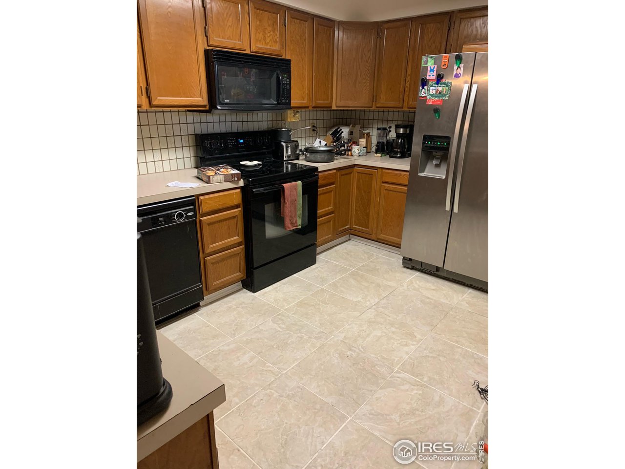 840 Wade Road Longmont, CO 80503 - Photo 2 of 9 a kitchen with stainless steel appliances granite countertop a stove top oven a sink and dishwasher
