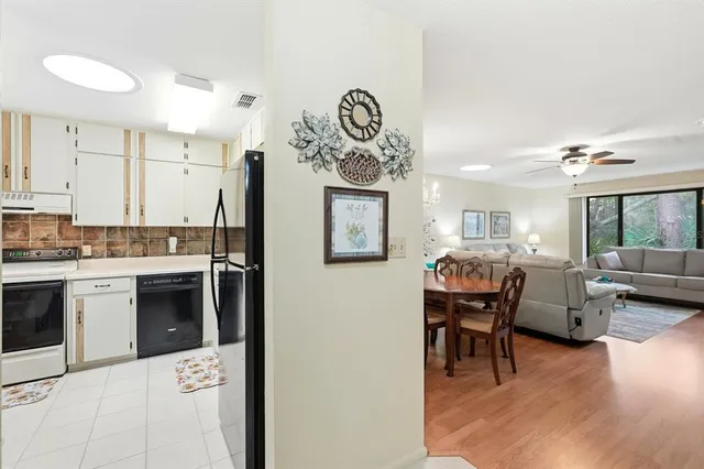 a kitchen with a refrigerator and a stove top oven