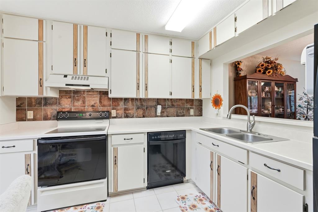 41 Crooked Pine Road Port Orange, FL 32128 - Photo 13 of 40 a kitchen with stainless steel appliances granite countertop a sink a stove and cabinets