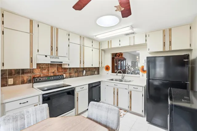 a kitchen with a sink stove and refrigerator