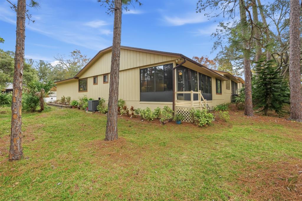 41 Crooked Pine Road Port Orange, FL 32128 - Photo 28 of 40 a house that has a big yard large trees with plants in front of it