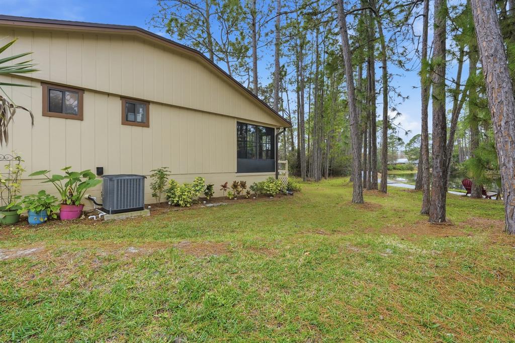 41 Crooked Pine Road Port Orange, FL 32128 - Photo 31 of 40 a view of a backyard with potted plants and large tree