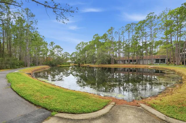 an aerial view of a house with large trees