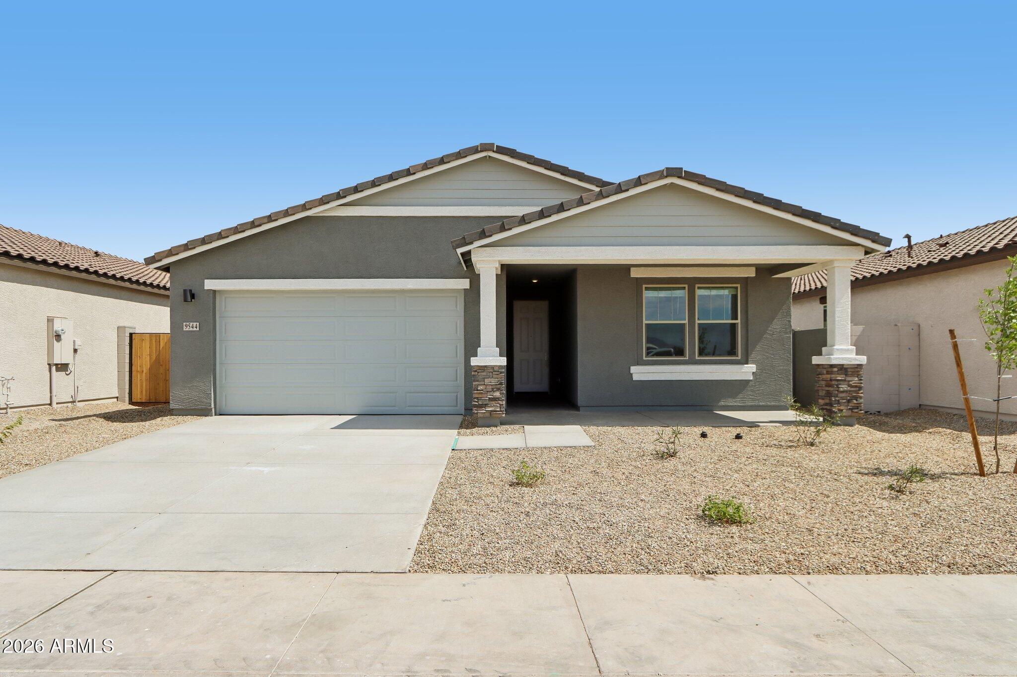 9544 West Gaby Road Tolleson, AZ 85353 - Photo 1 of 43 a front view of a house with a yard and garage