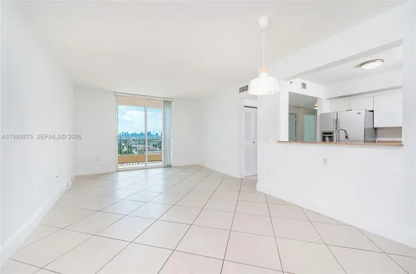 a view of a kitchen with a sink and a mirror