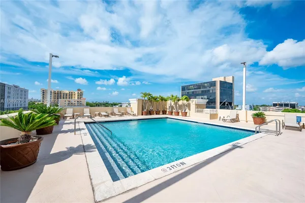 a view of a swimming pool with a lounge chairs