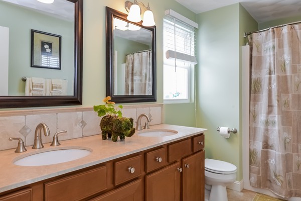 83 Scenic Way Exeter, RI 02822 - Photo 15 of 24 a bathroom with a double vanity sink toilet and a mirror