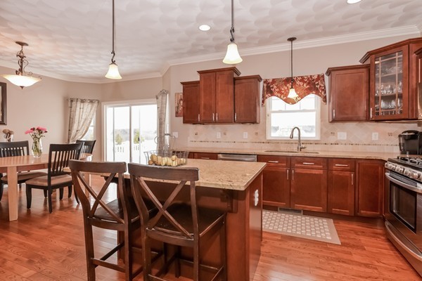 83 Scenic Way Exeter, RI 02822 - Photo 4 of 24 a kitchen with a table chairs and wooden floors