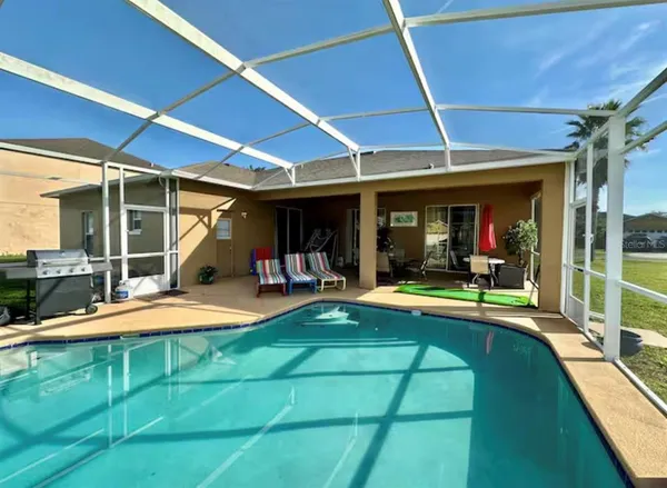 a view of a swimming pool with an outdoor seating
