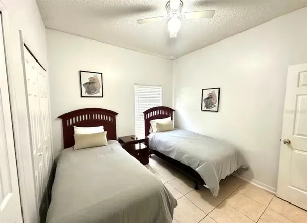 a bedroom with two beds and a chandelier
