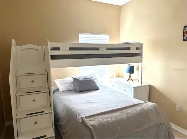 a bedroom with a bed and cabinet