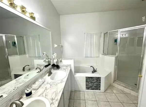 a bathroom with a tub sink and mirror