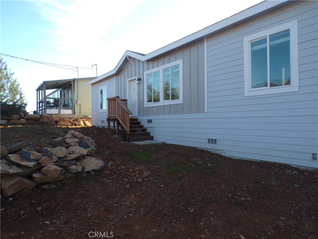 15305 Trinity Road Cobb, CA 95426 - Photo 2 of 12 a backyard of a house with barbeque oven table and chairs