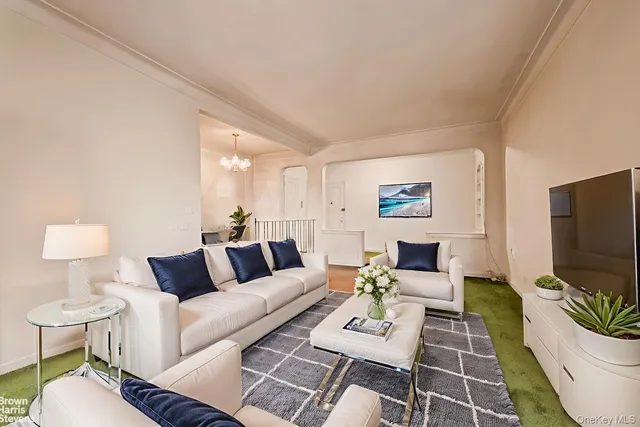 a living room with furniture a flat screen tv and a rug