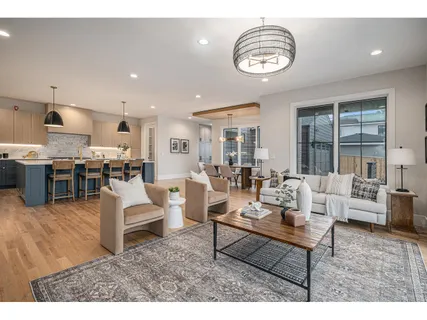 a living room with lots of furniture and kitchen view
