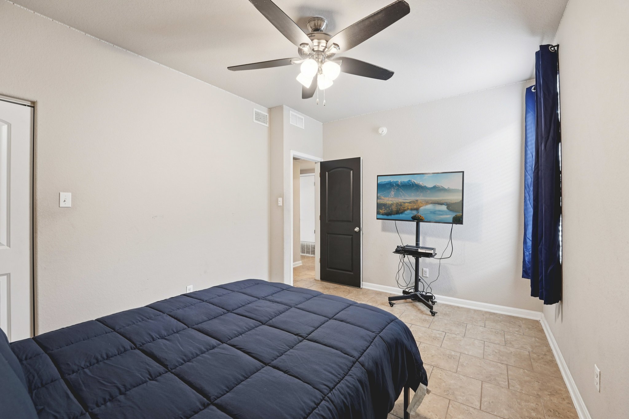 1048 Sanders Kyle, TX 78640 - Photo 11 of 18 a bedroom with a bed and a chandelier