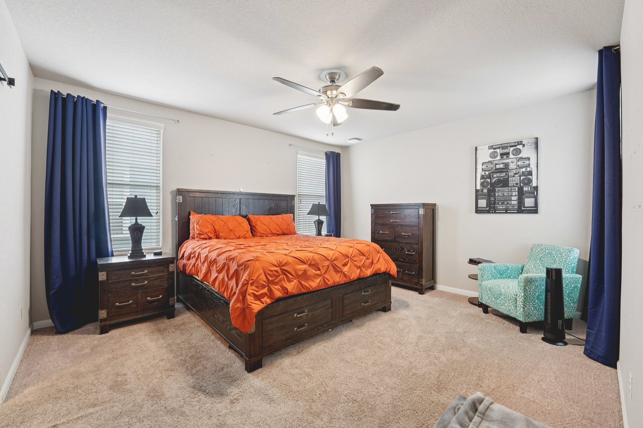 1048 Sanders Kyle, TX 78640 - Photo 12 of 18 a bed sitting in a spacious bedroom next to a window and a chandelier
