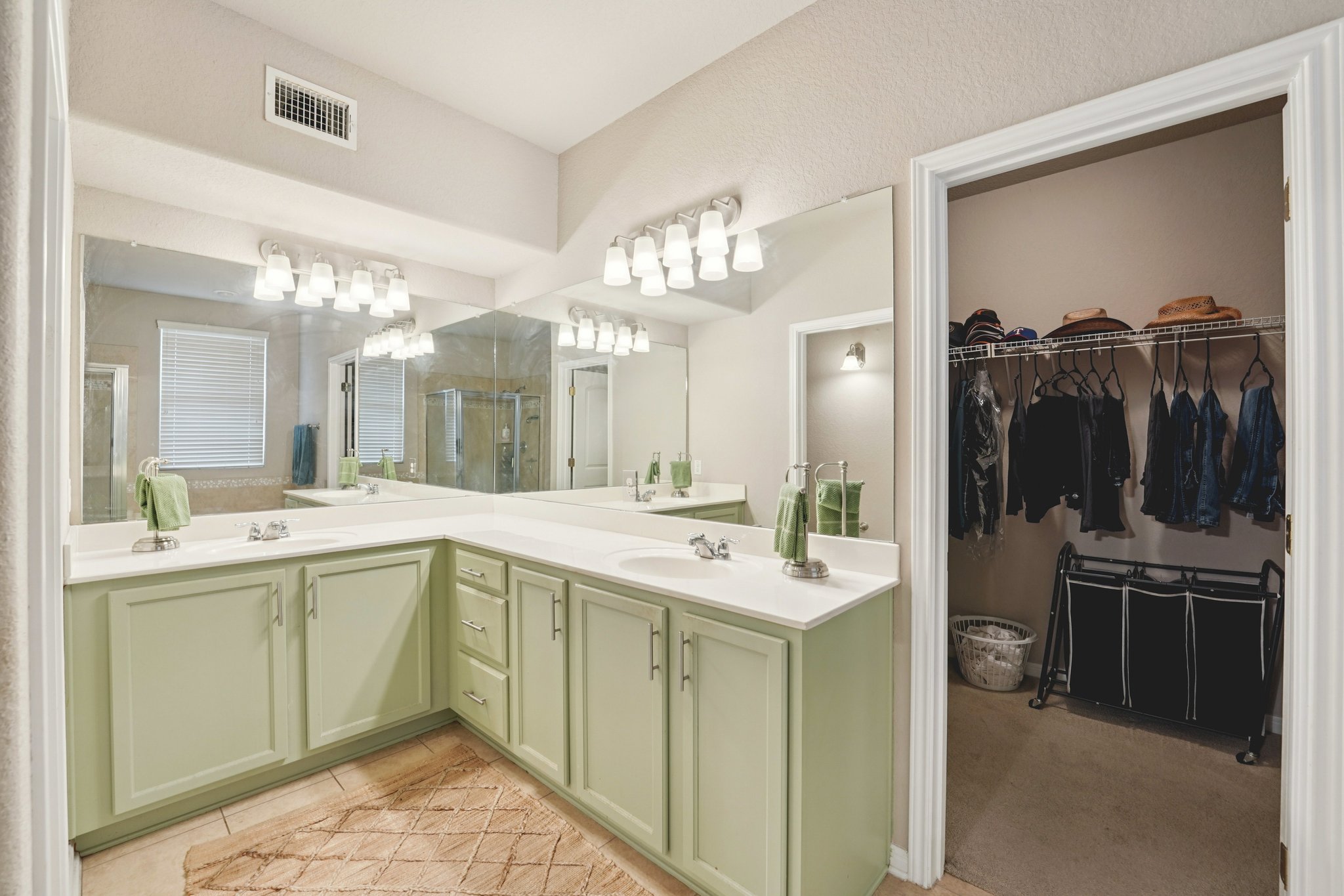 1048 Sanders Kyle, TX 78640 - Photo 13 of 18 a spacious bathroom with a sink a large mirror and a shower