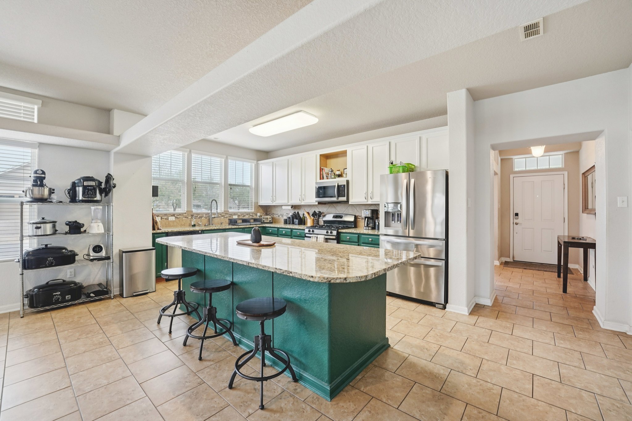 1048 Sanders Kyle, TX 78640 - Photo 6 of 18 a large kitchen with kitchen island a table and chairs