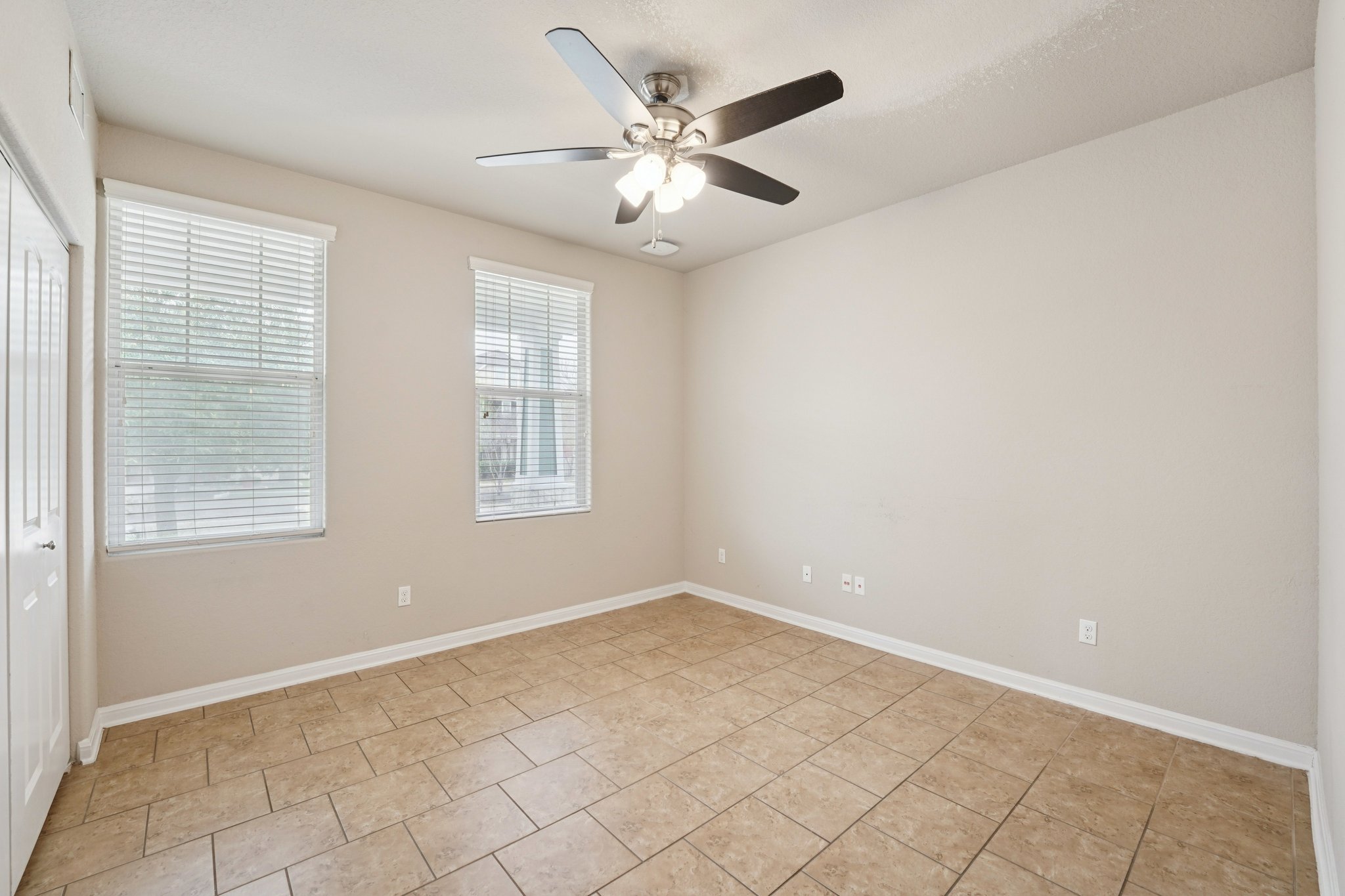 1048 Sanders Kyle, TX 78640 - Photo 8 of 18 an empty room with chandelier fan and windows