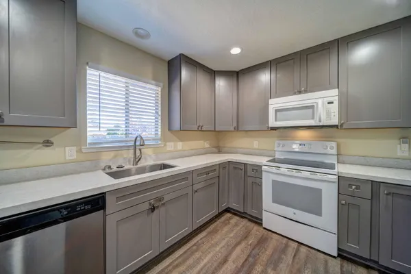 a kitchen with a sink stove and cabinets