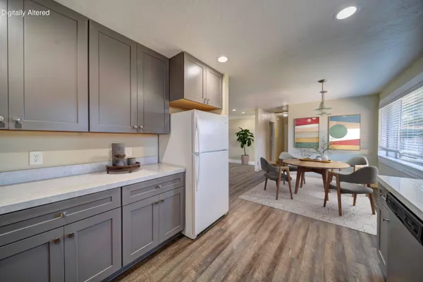 a kitchen with sink cabinets and wooden floor