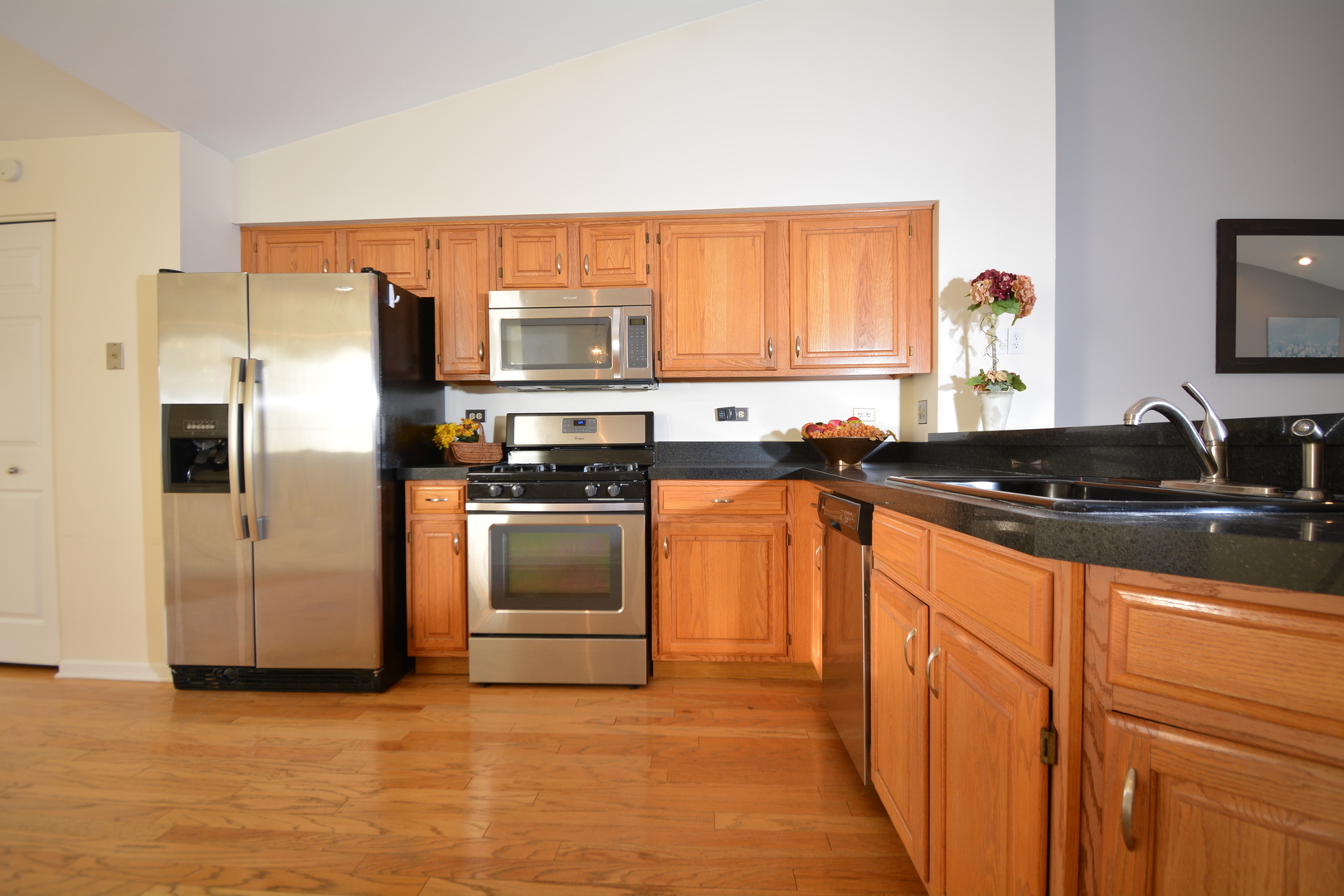 8249 Ripple Ridge Darien, IL 60561 - Photo 8 of 27 a kitchen with stainless steel appliances granite countertop a refrigerator and a sink