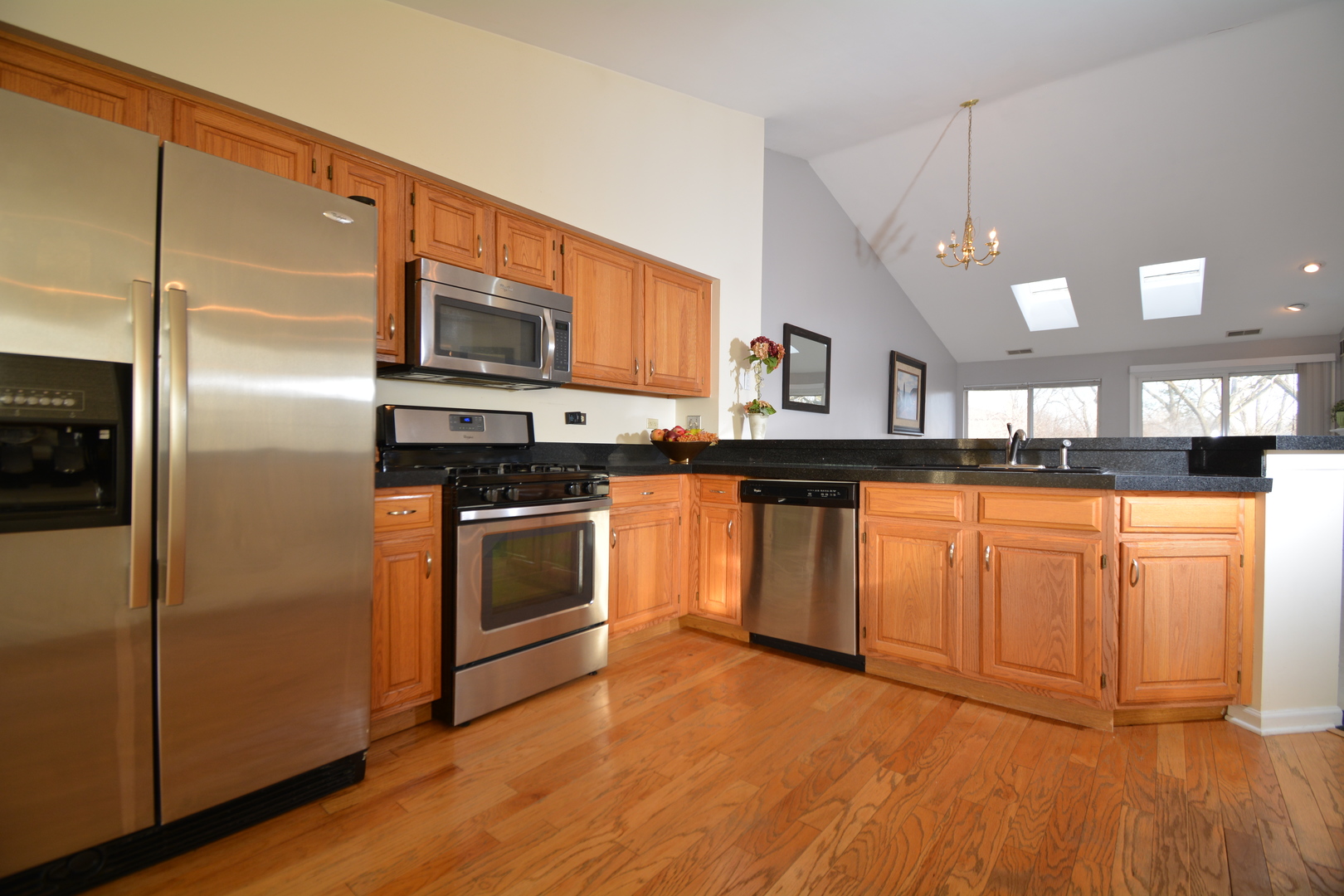 8249 Ripple Ridge Darien, IL 60561 - Photo 9 of 27 a kitchen with stainless steel appliances granite countertop a stove a sink and a microwave