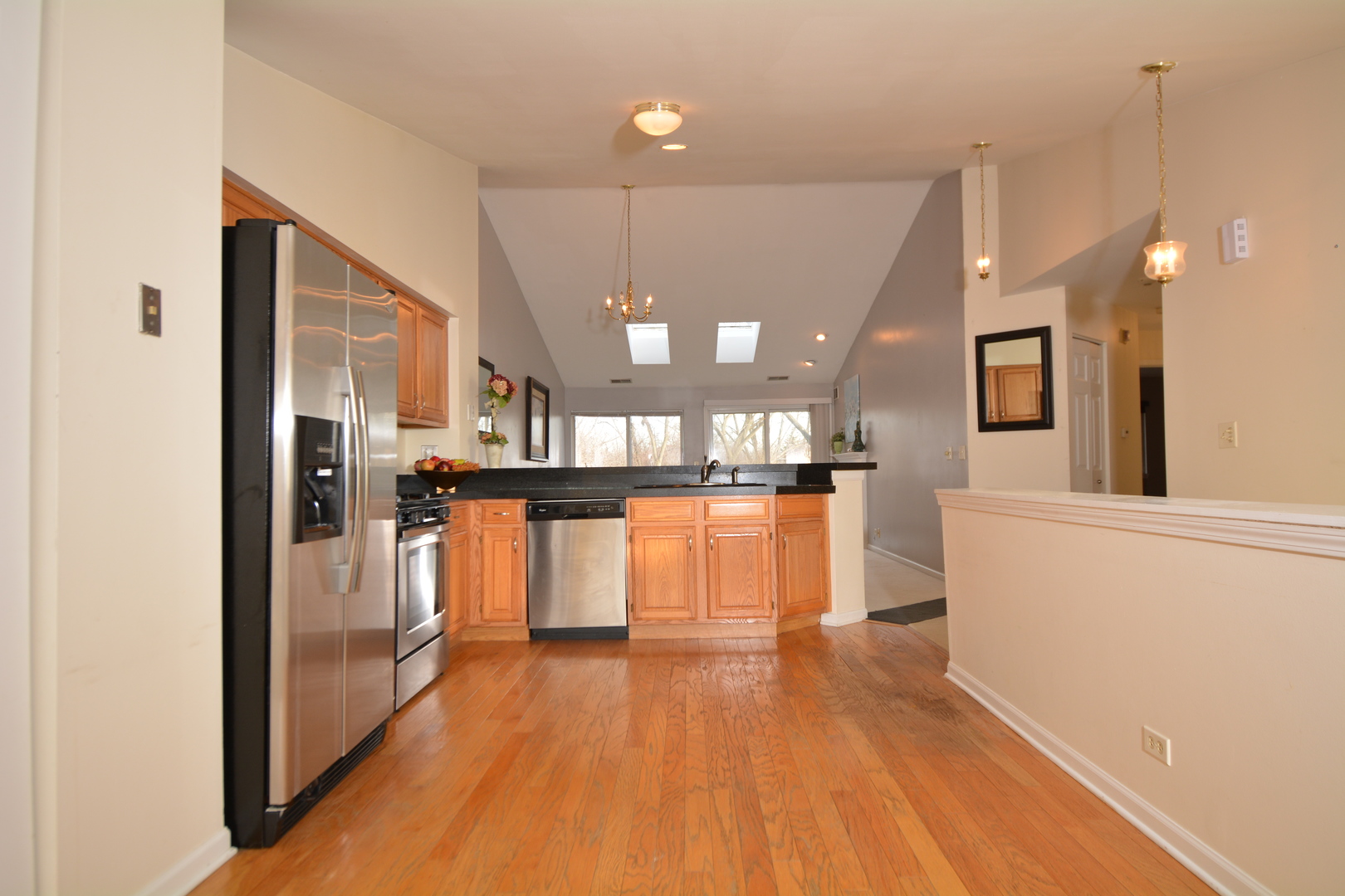 8249 Ripple Ridge Darien, IL 60561 - Photo 10 of 27 a view of a kitchen with refrigerator and wooden floor
