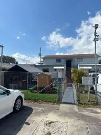 a view of a house with backyard and porch