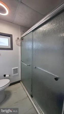 a bathroom with a shower and a toilet
