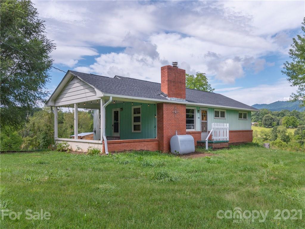 358 Coffee Branch Road Canton, NC 28716 - Photo 1 of 19 a front view of a house with garden and porch
