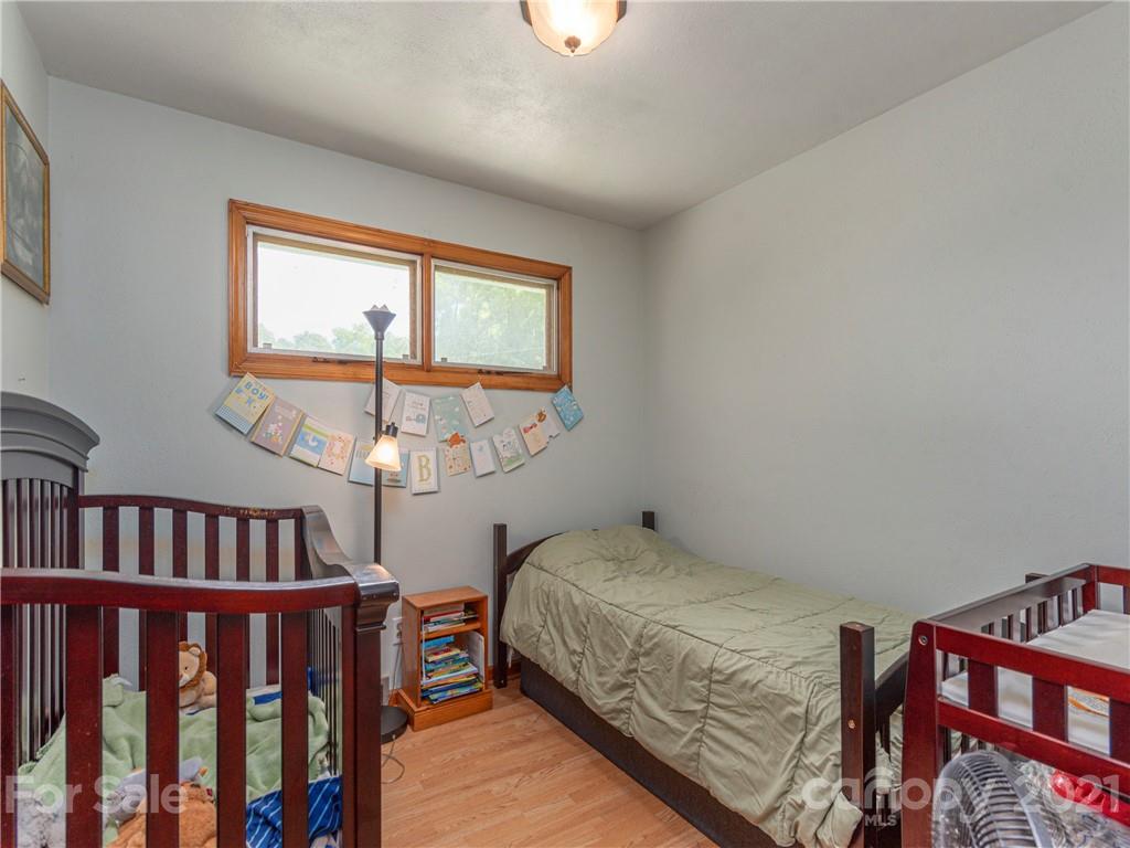 358 Coffee Branch Road Canton, NC 28716 - Photo 11 of 19 a bedroom with a bed and a window