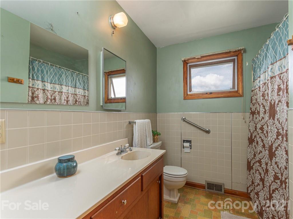 358 Coffee Branch Road Canton, NC 28716 - Photo 12 of 19 a bathroom with a toilet sink and mirror