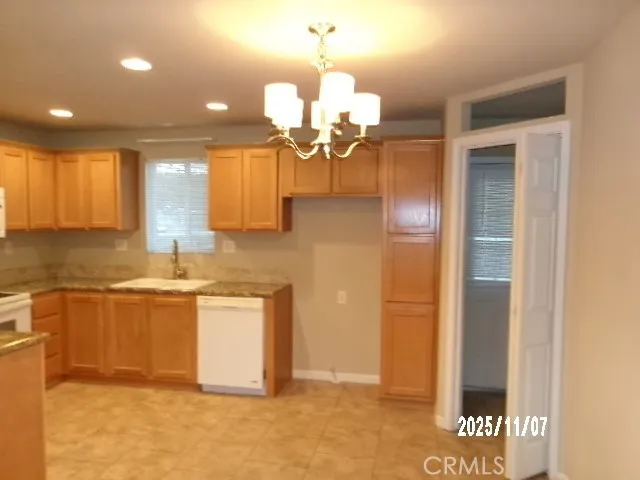 a kitchen with stainless steel appliances granite countertop a sink and a refrigerator