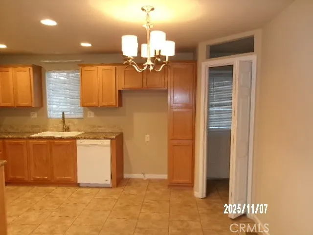 a view of a kitchen with a sink and chandelier