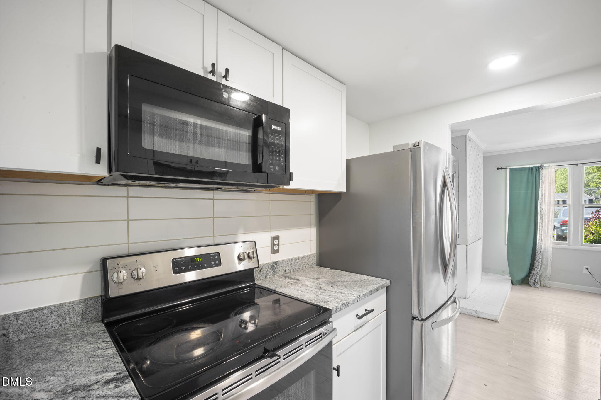 7728 Crown Crest Court Raleigh, NC 27615 - Photo 13 of 38 a kitchen with a refrigerator stove and microwave