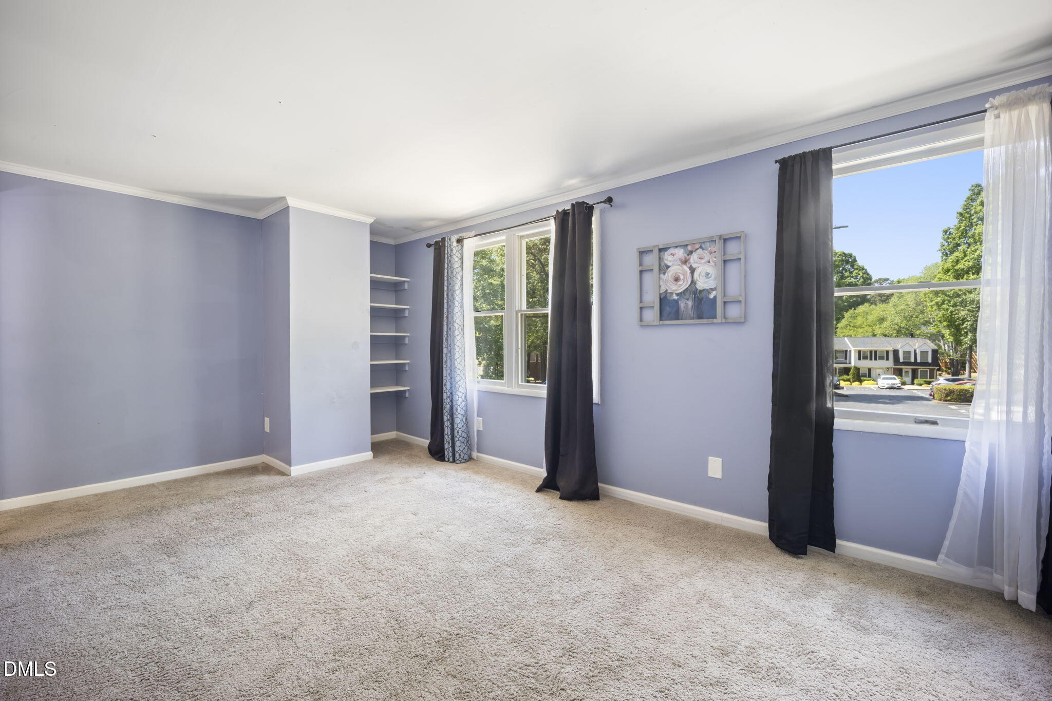 7728 Crown Crest Court Raleigh, NC 27615 - Photo 18 of 38 an empty room with windows closet and chandelier fan