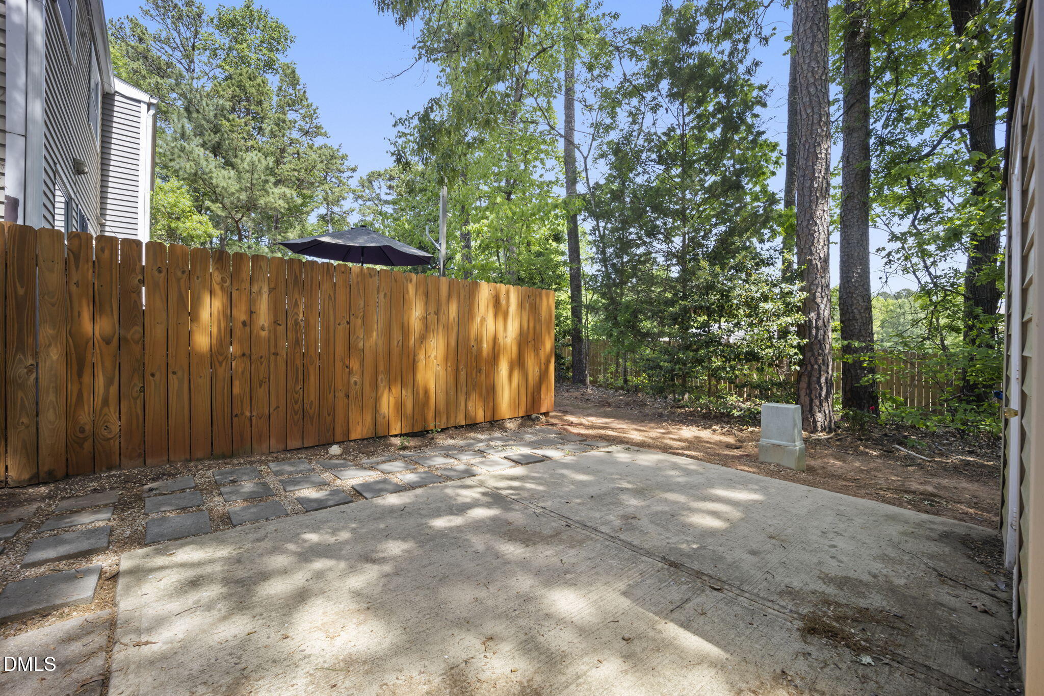 7728 Crown Crest Court Raleigh, NC 27615 - Photo 28 of 38 a view of backyard with tree and wooden fence