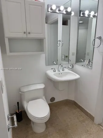 a bathroom with a sink a toilet and mirror