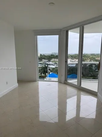 a view of an empty room with a floor to ceiling window and a room