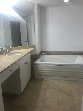 a bathroom with a bathtub and a sink