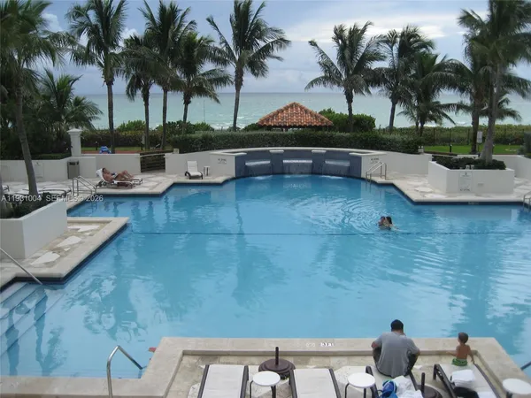 a view of a backyard and swimming pool