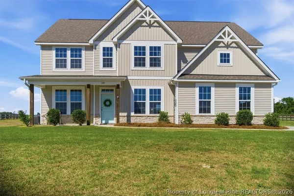 a front view of a house with a yard